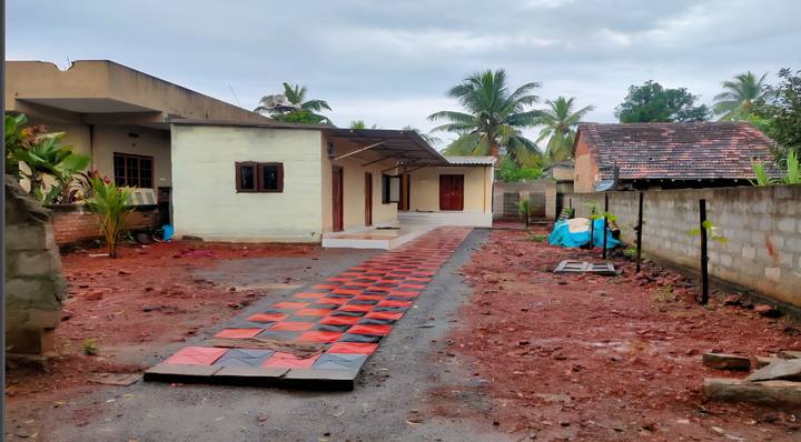 Single-storey buildings of the Home beside a tiled path