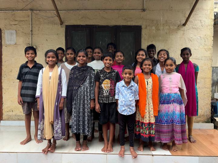 Children of the Home standing together outside a building